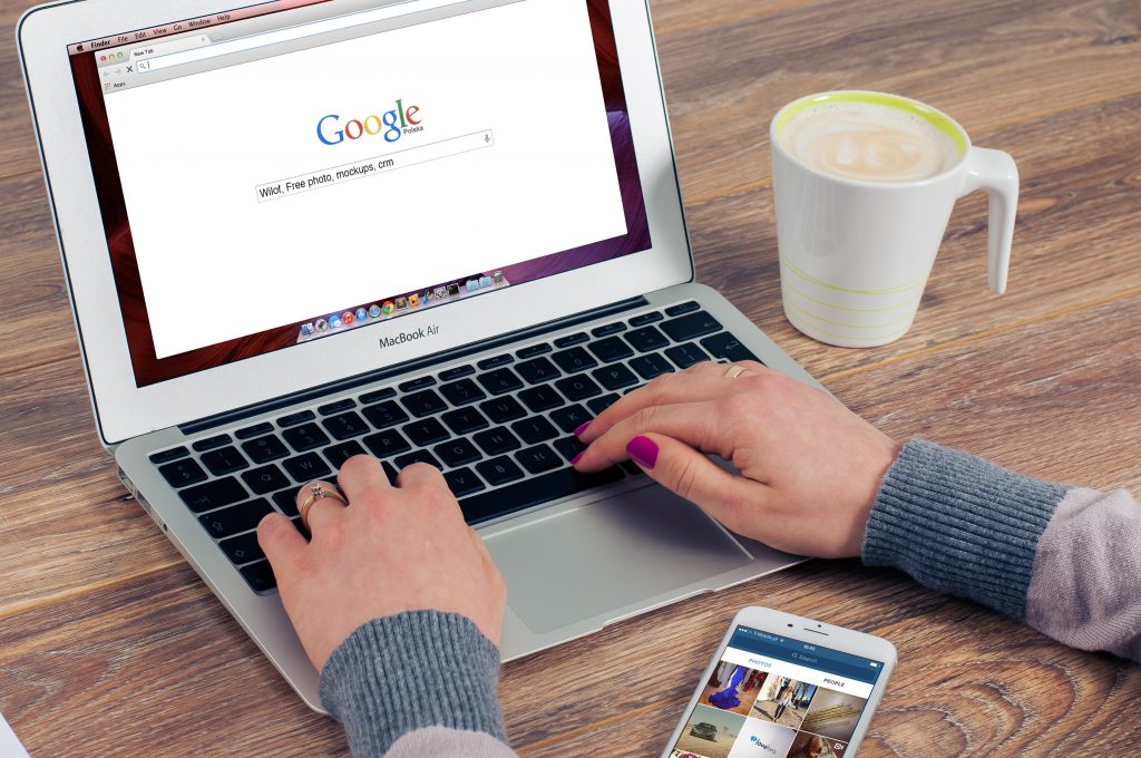 woman writing on laptop