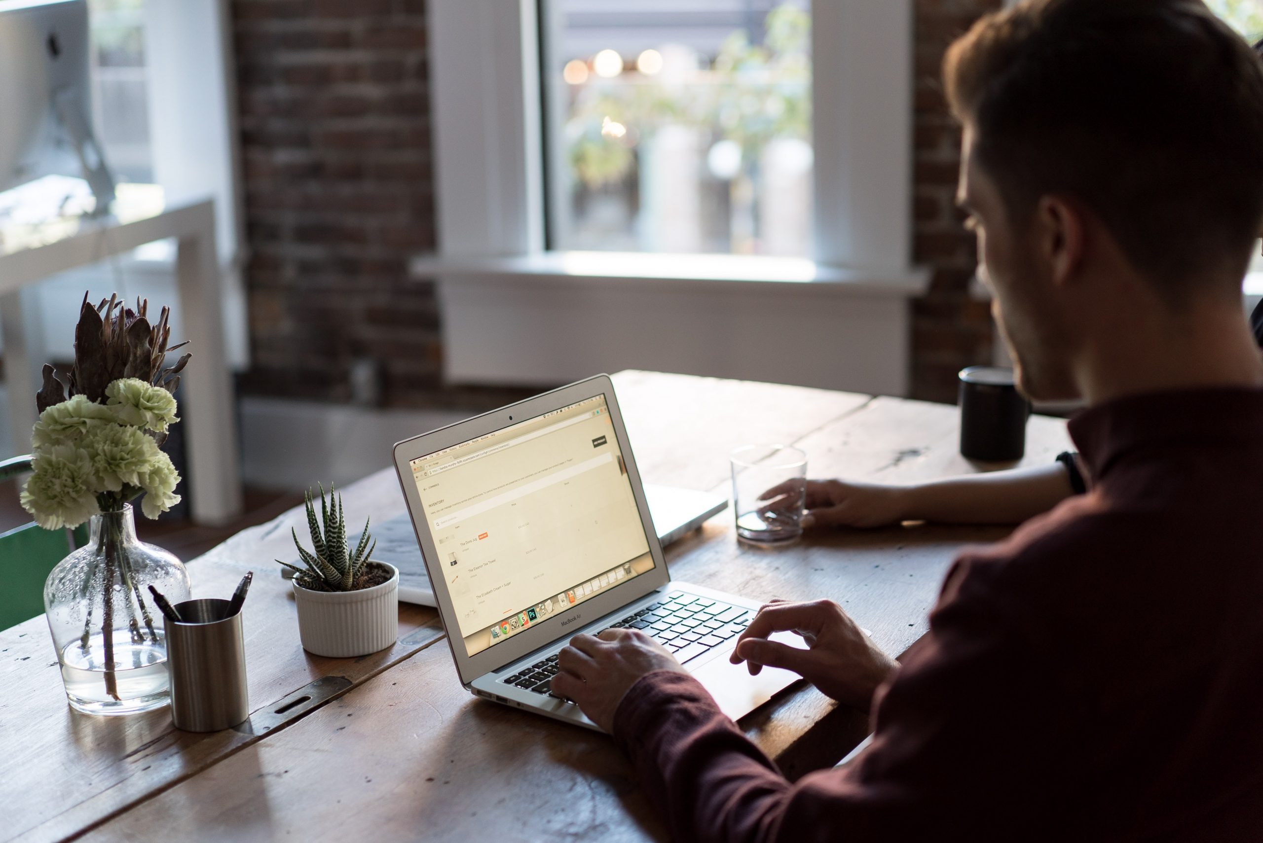 man writing on a laptop