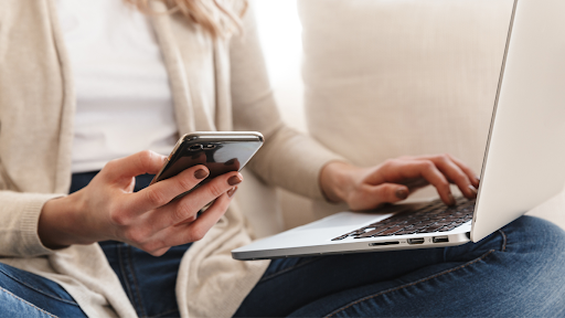 woman-using-phone-and-laptop